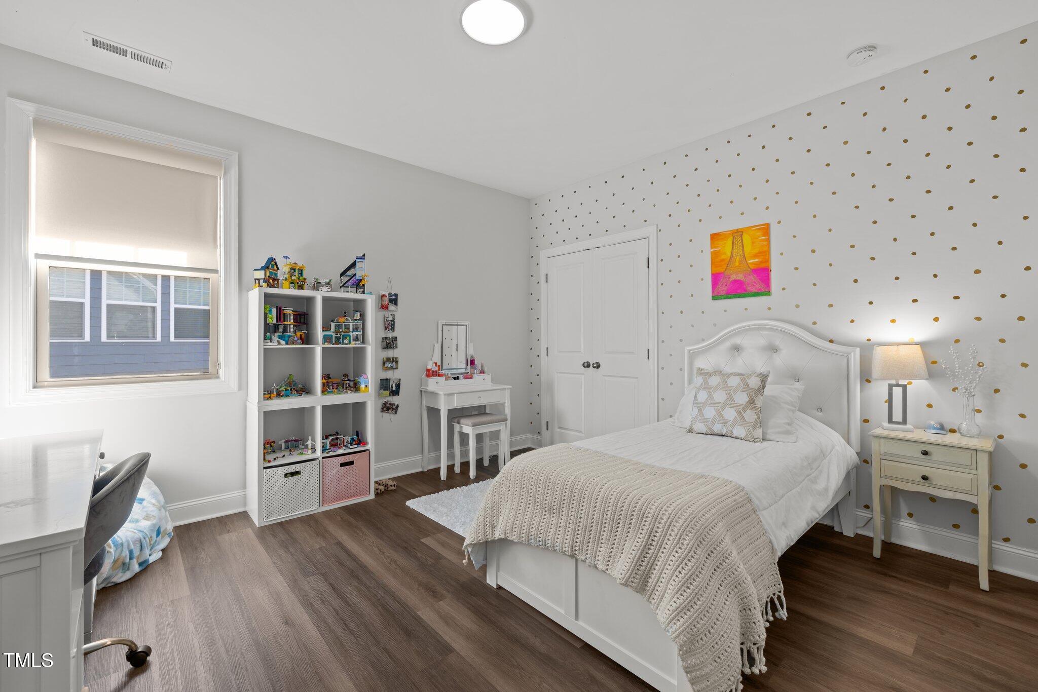 98 Stone Bridge Crossing Chapel Hill, NC 27517 - Photo 21 of 37 a bedroom with a bed and a bookshelf with wooden floor