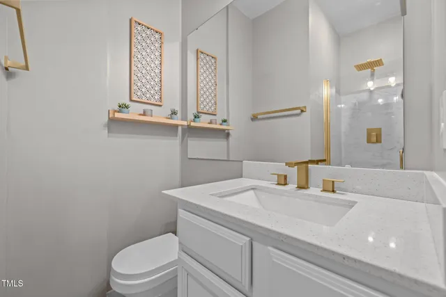 a bathroom with a sink a toilet and mirror