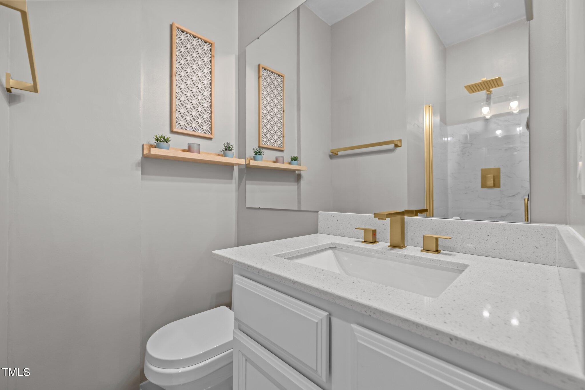 98 Stone Bridge Crossing Chapel Hill, NC 27517 - Photo 22 of 37 a bathroom with a sink a toilet and mirror