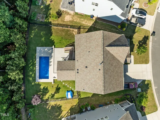 an aerial view of a house with a yard