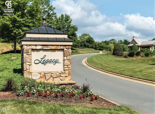 a sign that is sitting on a wooden fence