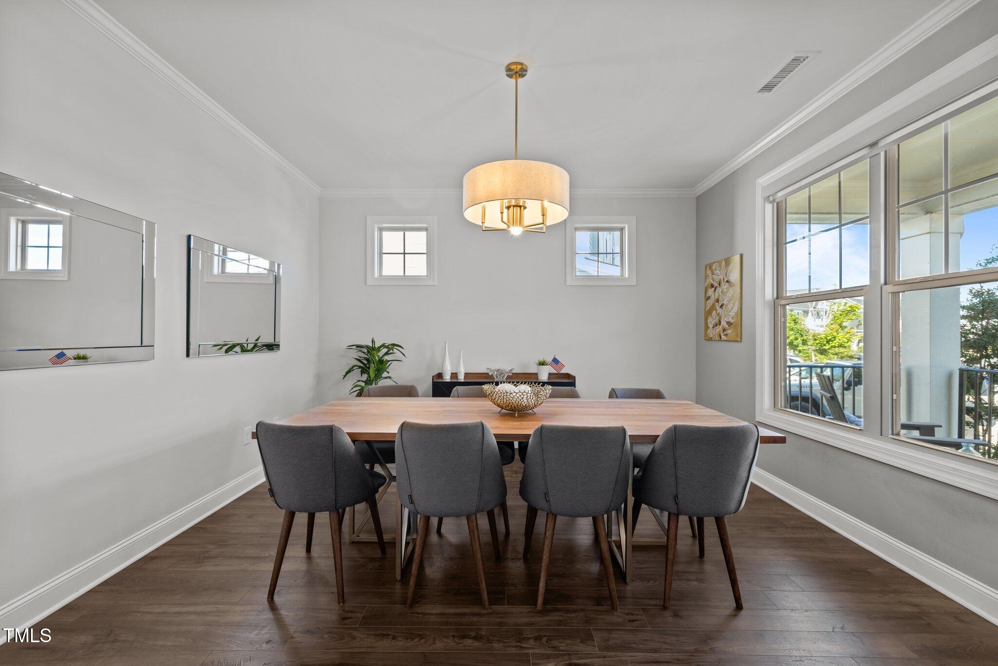 98 Stone Bridge Crossing Chapel Hill, NC 27517 - Photo 3 of 37 a view of a dining room with furniture a chandelier and wooden floor