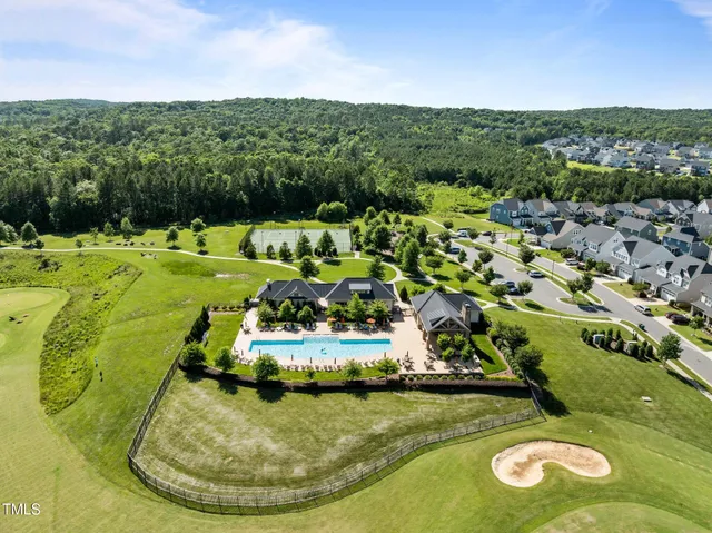 a view of a swimming pool with a yard and mountain view