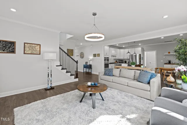 a living room with furniture and kitchen view