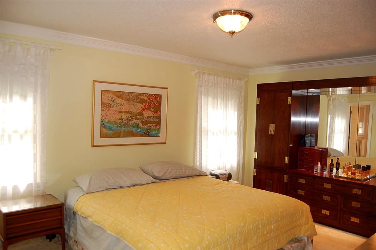 800 Purdue Street Raleigh, NC 27609 - Photo 12 of 21 a bedroom with a bed and a chandelier