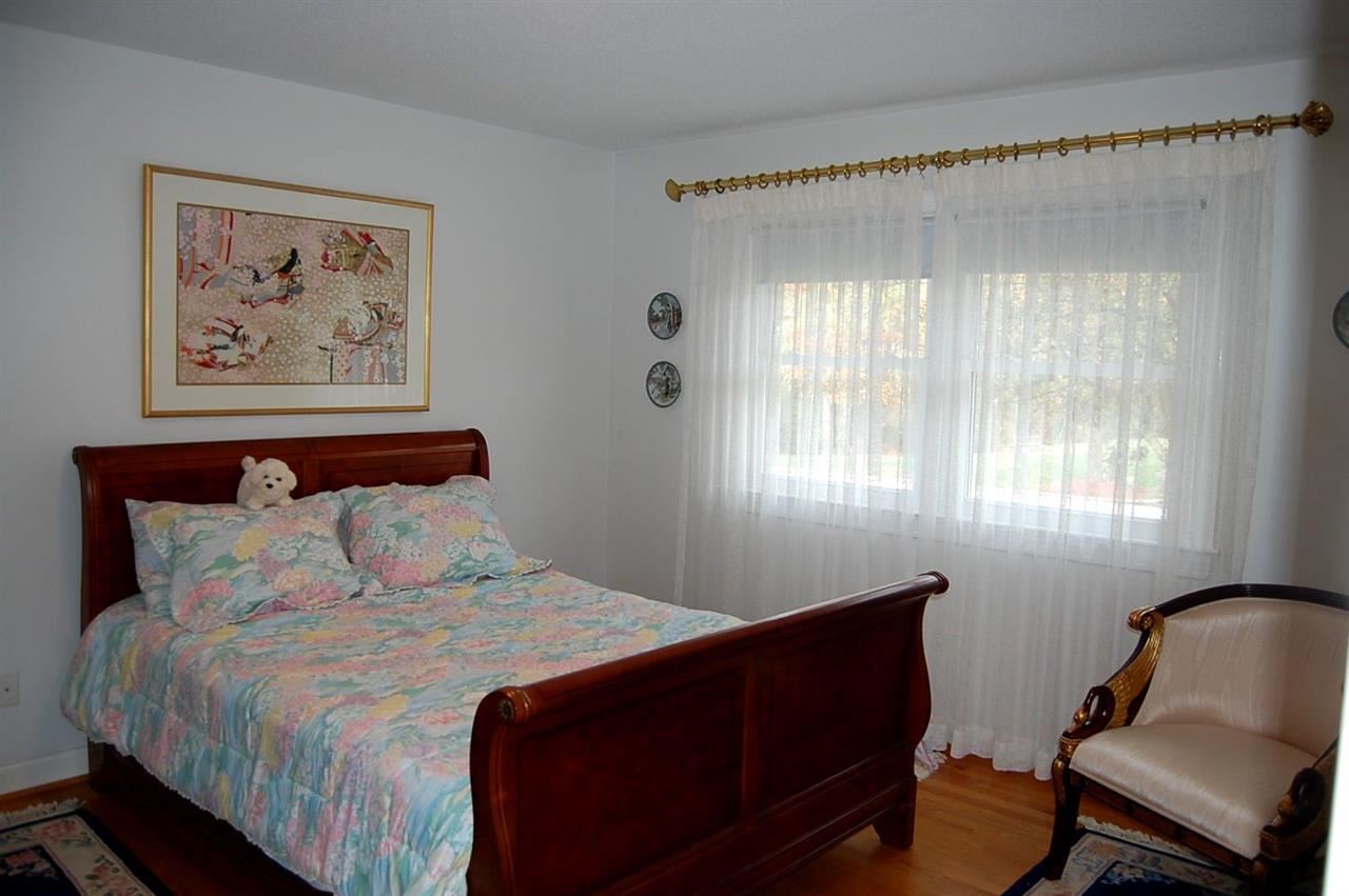 800 Purdue Street Raleigh, NC 27609 - Photo 14 of 21 a bedroom with a bed and a chair