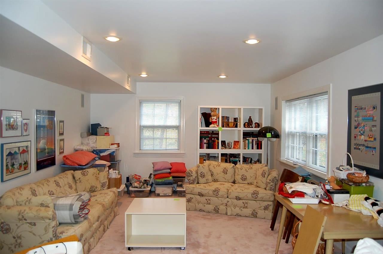 800 Purdue Street Raleigh, NC 27609 - Photo 17 of 21 a living room filled with furniture a window and gym equipment