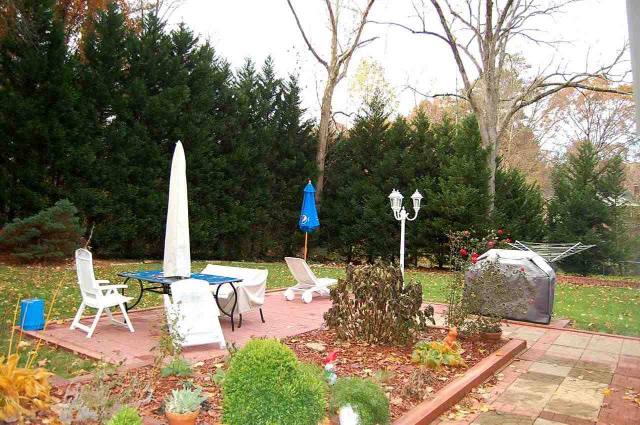 800 Purdue Street Raleigh, NC 27609 - Photo 21 of 21 a view of a patio with table and chairs potted plants and palm trees