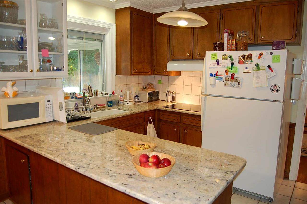 800 Purdue Street Raleigh, NC 27609 - Photo 6 of 21 a kitchen with a refrigerator a stove a sink and a kitchen island