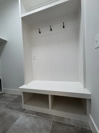 an empty room with a window and a ceiling fan