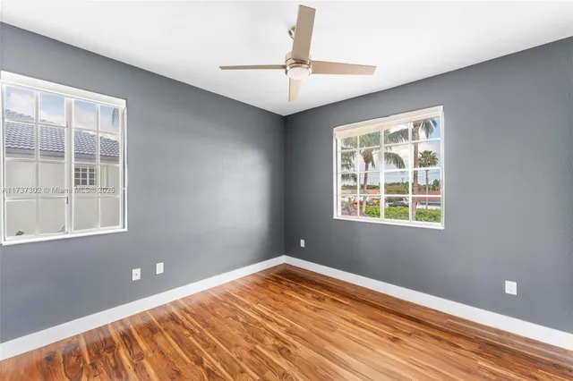 a bedroom with a bed and a ceiling fan