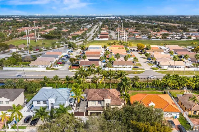 an aerial view of multiple houses with yard