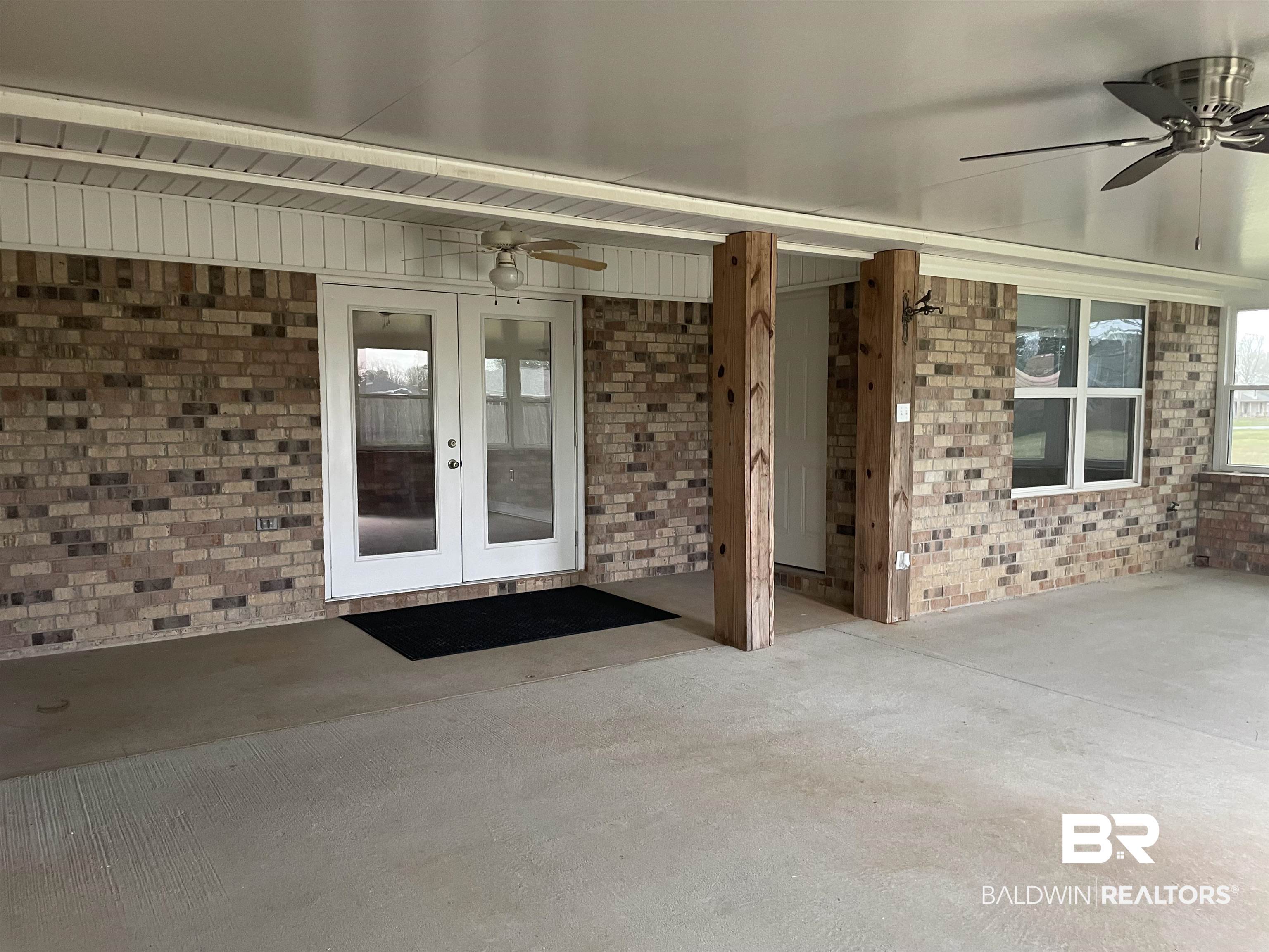 23575 Fountain Street Robertsdale, AL 36567 - Photo 16 of 19 Entrance to property featuring ceiling fan, french doors, and brick siding