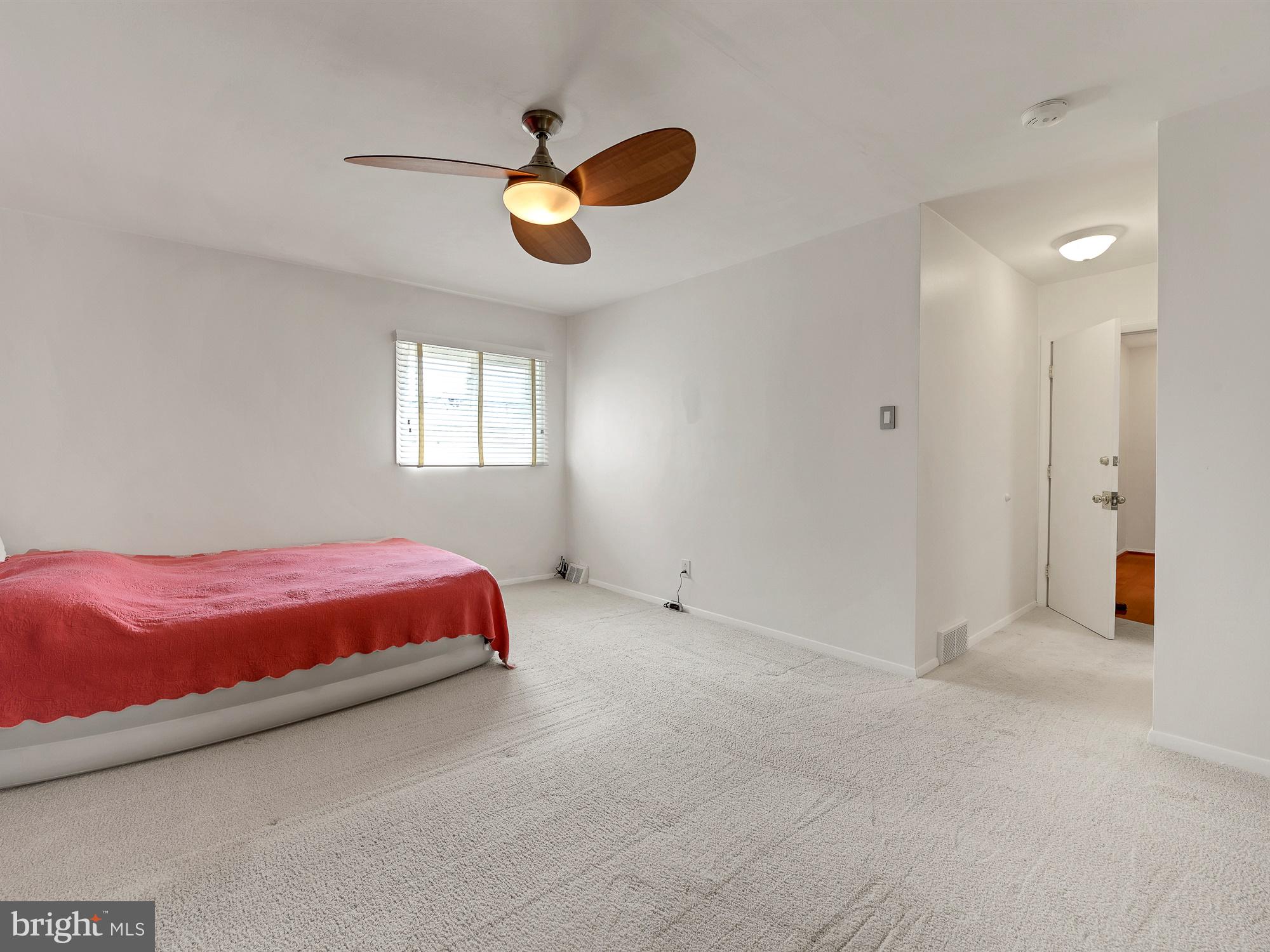 125 Juniper Road Havertown, PA 19083 - Photo 14 of 32 a spacious bedroom with a bed and chandelier fan