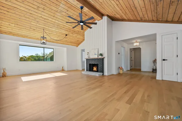 a view of empty room with a fireplace
