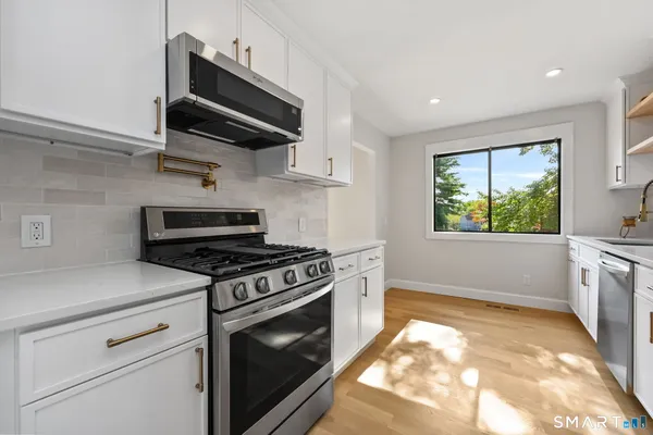 a stove top oven sitting inside of a kitchen