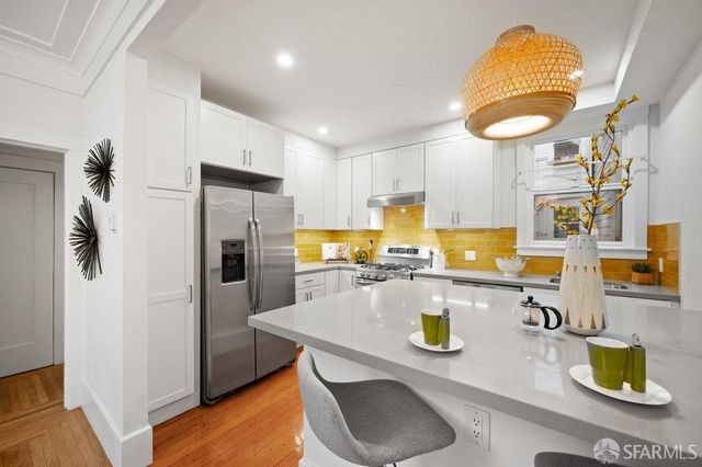 a kitchen with a sink a stove and cabinets