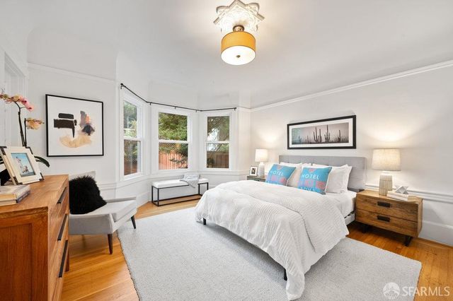 a bedroom with a bed and windows