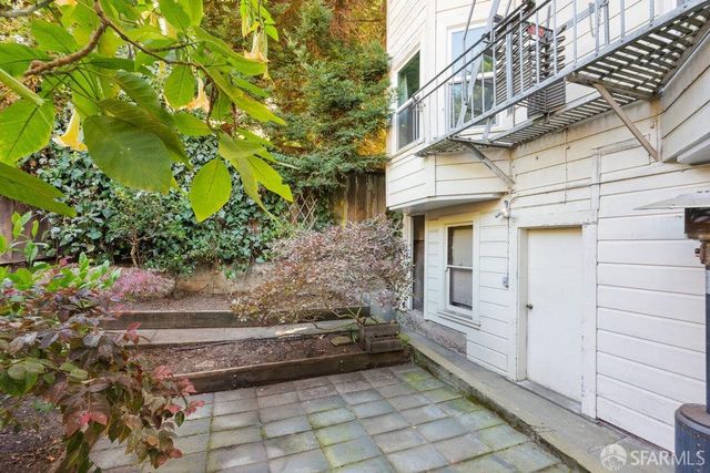 a front view of a house with a garden and yard