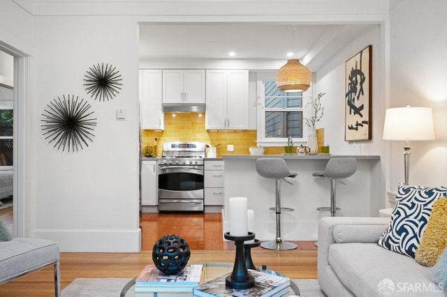 a kitchen with a sink a stove and a refrigerator