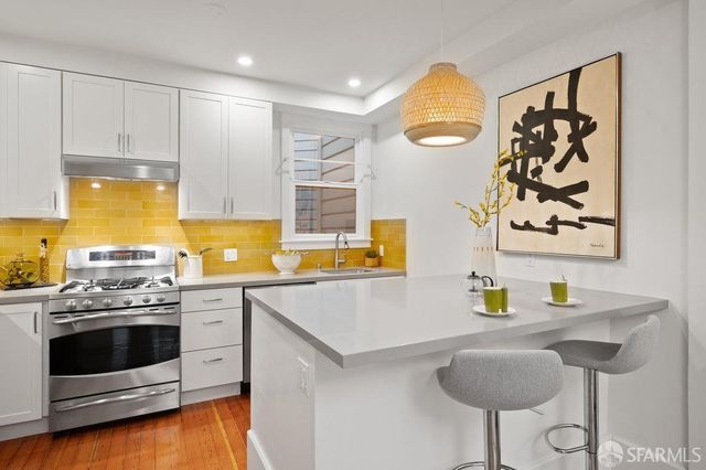 a kitchen with refrigerator and a sink