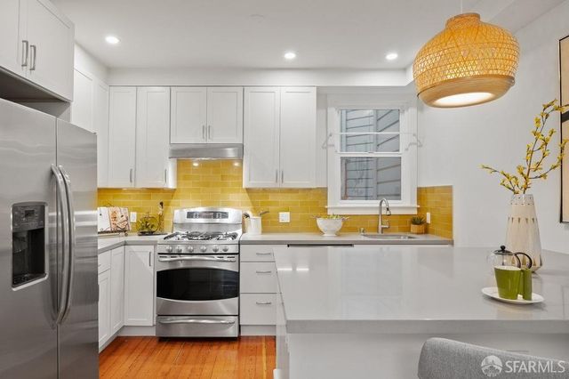 a kitchen with a sink a stove and refrigerator