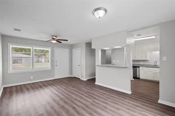 a view of kitchen with wooden floor and electronic appliances