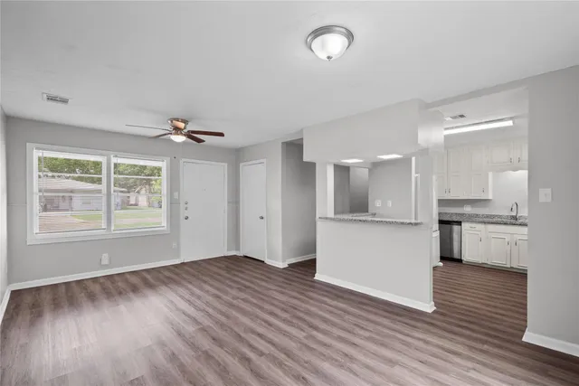 a view of kitchen with wooden floor and electronic appliances