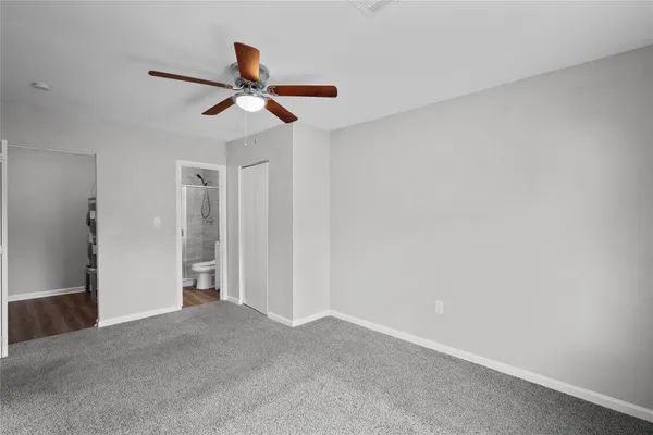 a view of empty room with ceiling fan