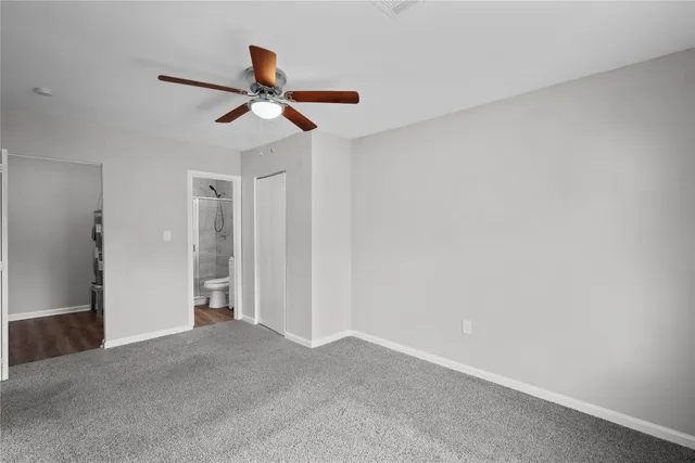 a view of empty room with ceiling fan