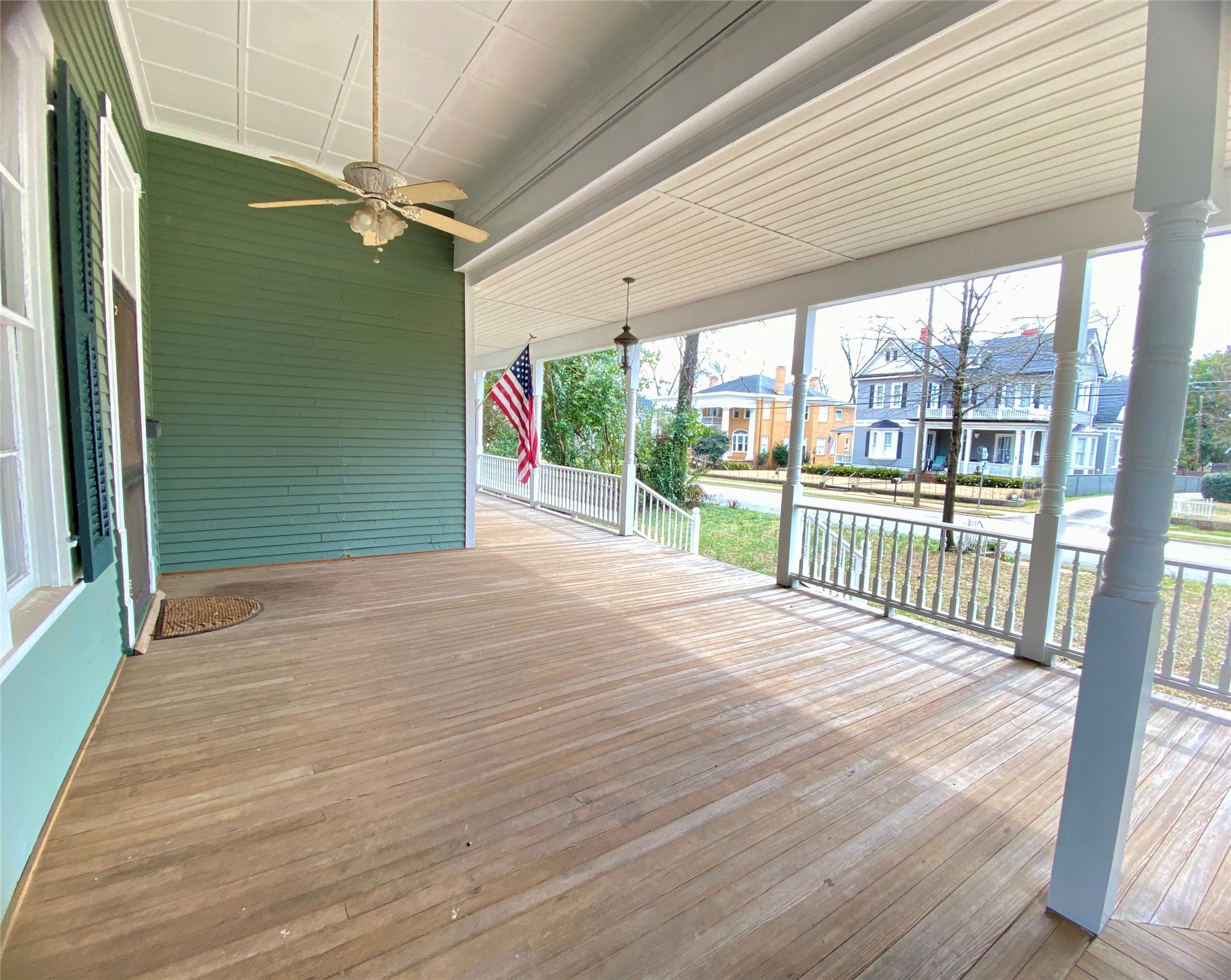 223 East Robert Toombs Avenue Washington, GA 30673 - Photo 6 of 46 an empty room with wooden floor and balcony