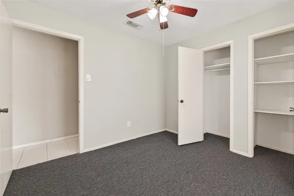 an empty room with a empty space and a ceiling fan
