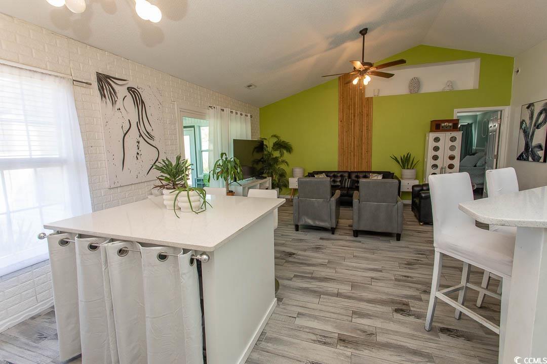 761 Drawbridge Drive Conway, SC 29526 - Photo 36 of 36 Kitchen with a breakfast bar, lofted ceiling, a peninsula, light wood-style flooring, and open floor plan