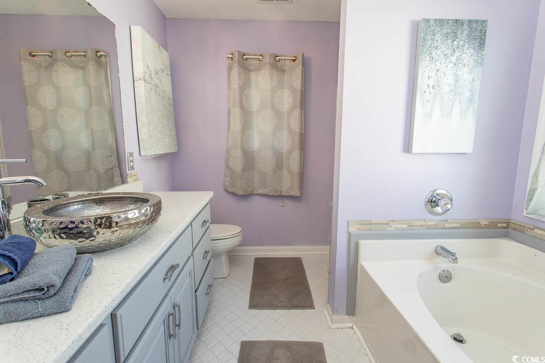 761 Drawbridge Drive Conway, SC 29526 - Photo 13 of 36 Full bath featuring vanity, a garden tub, light floors, and a textured ceiling