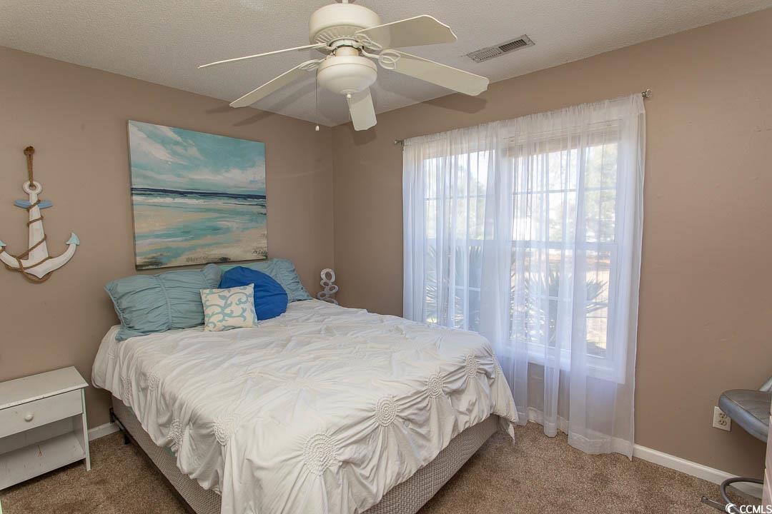 761 Drawbridge Drive Conway, SC 29526 - Photo 16 of 36 Bedroom featuring carpet floors, a ceiling fan, and a textured ceiling