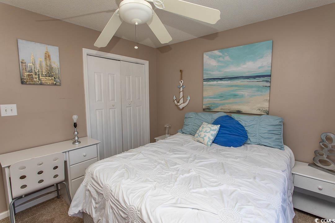 761 Drawbridge Drive Conway, SC 29526 - Photo 17 of 36 Bedroom with carpet floors, a ceiling fan, a closet, and a textured ceiling