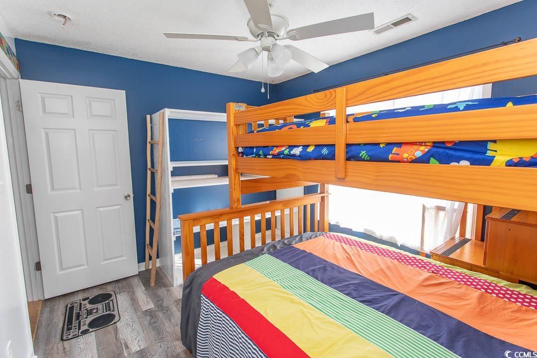 761 Drawbridge Drive Conway, SC 29526 - Photo 21 of 36 Bedroom featuring wood finished floors, a ceiling fan, and a textured ceiling