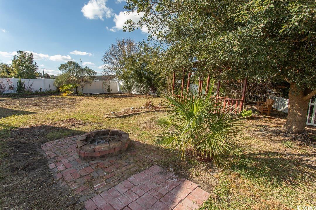 761 Drawbridge Drive Conway, SC 29526 - Photo 27 of 36 Fenced backyard featuring an outdoor fire pit and a patio area