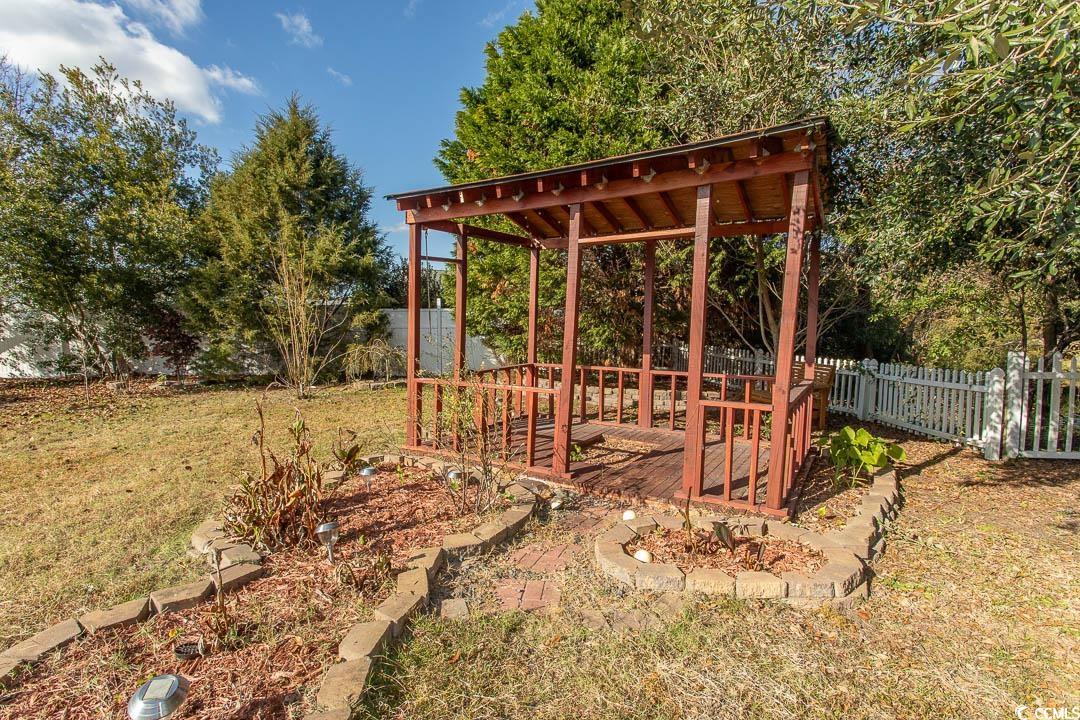 761 Drawbridge Drive Conway, SC 29526 - Photo 28 of 36 View of yard with a vegetable garden and a deck