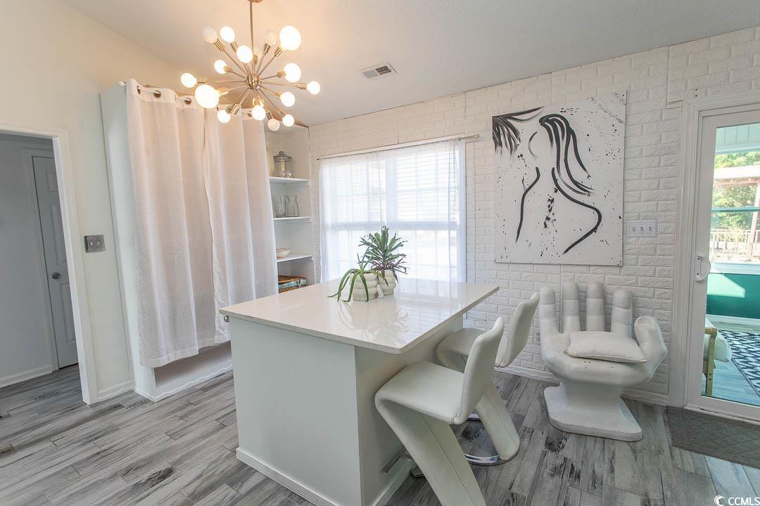 761 Drawbridge Drive Conway, SC 29526 - Photo 10 of 36 Dining area with light wood-style flooring and a chandelier