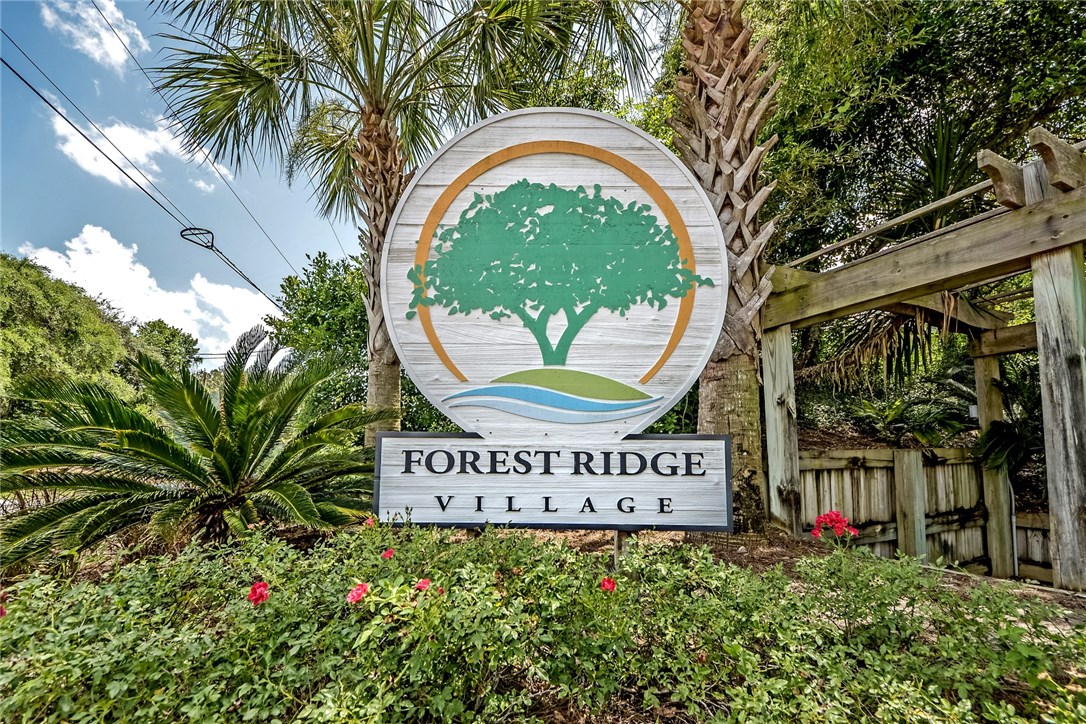 2743 Forest Ridge Drive, Unit I3 Fernandina Beach, FL 32034 - Photo 21 of 21 a sign that is sitting in front of flowers