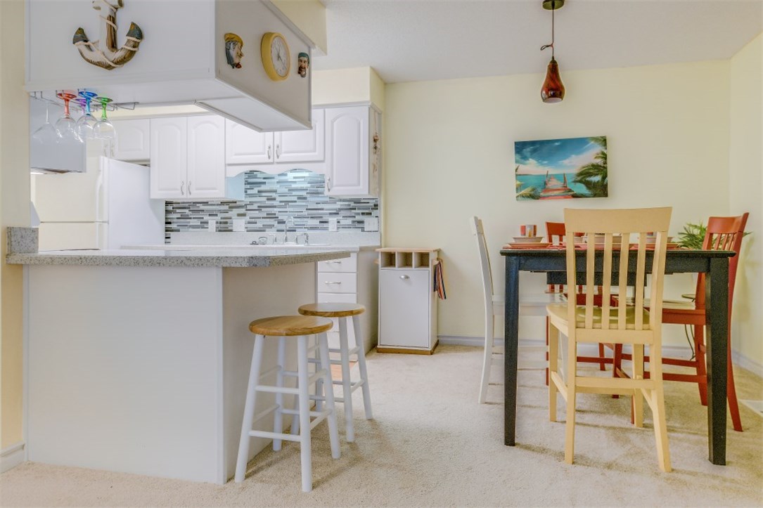 2743 Forest Ridge Drive, Unit I3 Fernandina Beach, FL 32034 - Photo 8 of 21 a room with a table and chairs