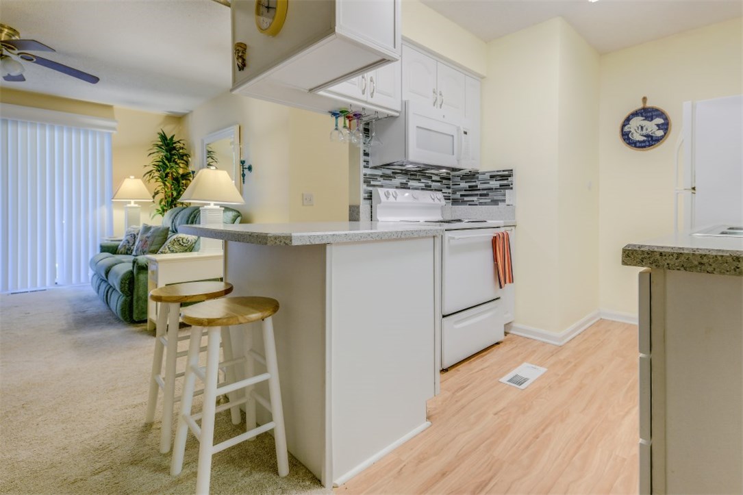 2743 Forest Ridge Drive, Unit I3 Fernandina Beach, FL 32034 - Photo 9 of 21 a kitchen with stainless steel appliances granite countertop a sink and cabinets
