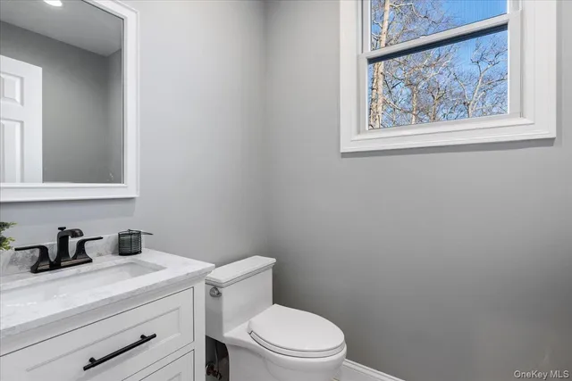 a white toilet sitting next to a bathroom sink