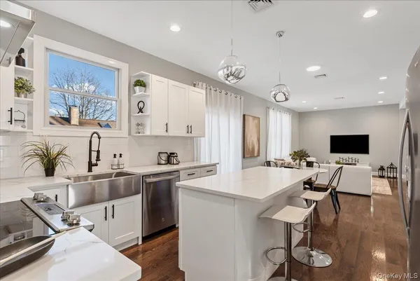 a large kitchen with a table and chairs