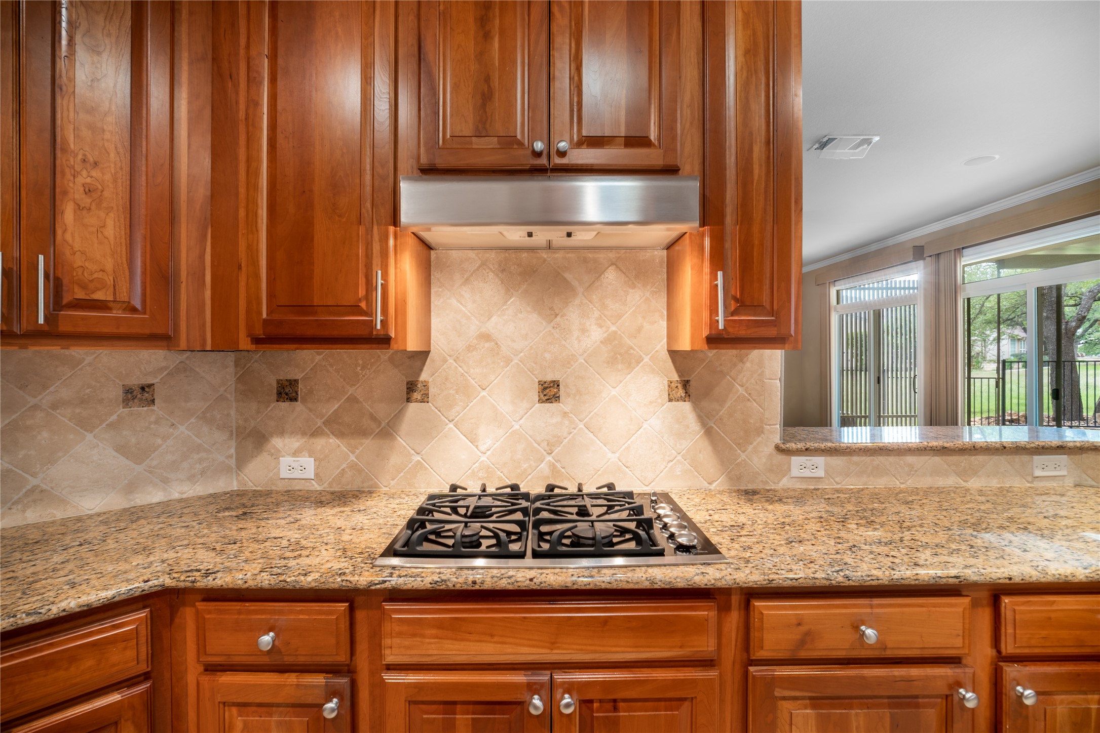 214 Summit Street Georgetown, TX 78633 - Photo 14 of 38 Kitchen featuring wooden cabinetry, granite countertops, a gas cooktop, and a tiled backsplash