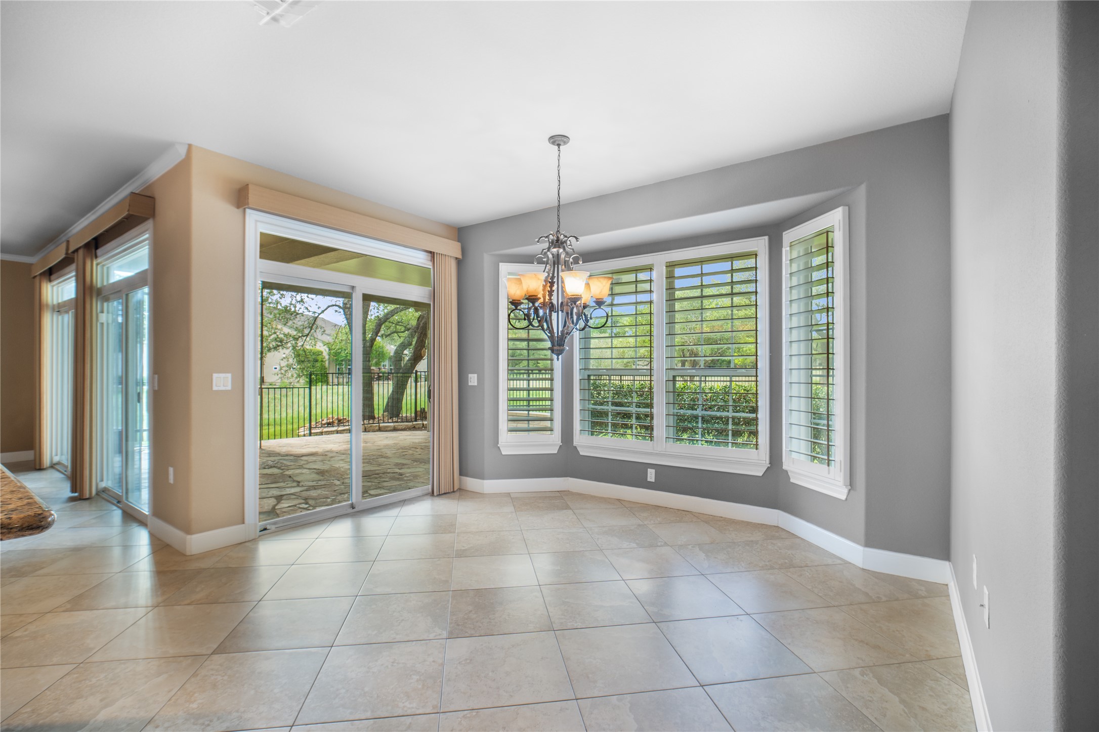 214 Summit Street Georgetown, TX 78633 - Photo 15 of 38 This versatile room features tile flooring, a bay window with plantation shutters, and a chandelier