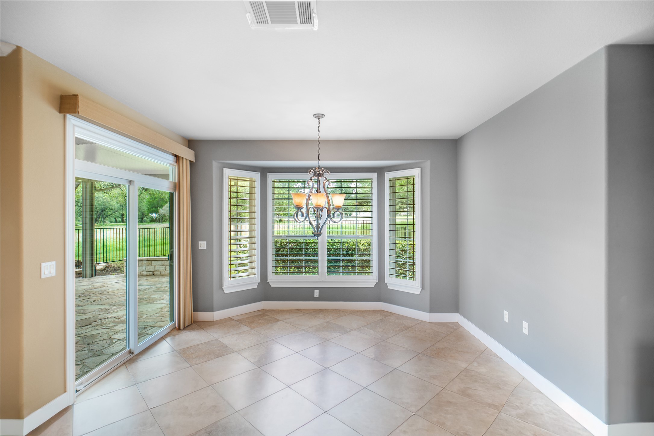 214 Summit Street Georgetown, TX 78633 - Photo 16 of 38 This room features tile flooring, a bay window with plantation shutters, and a chandelier
