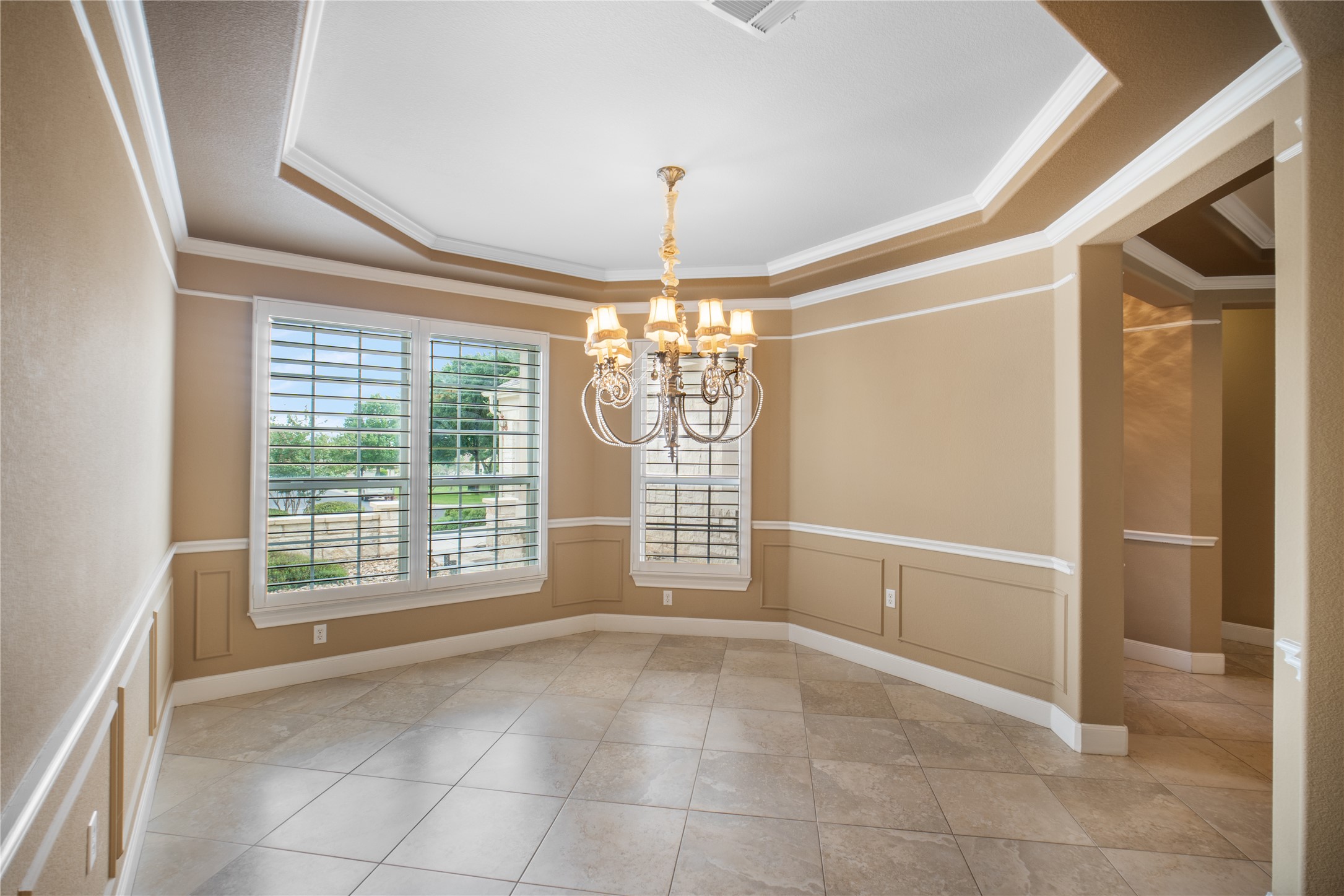 214 Summit Street Georgetown, TX 78633 - Photo 18 of 38 This room features light-colored tile flooring, decorative wainscoting, and large windows with plantation shutters