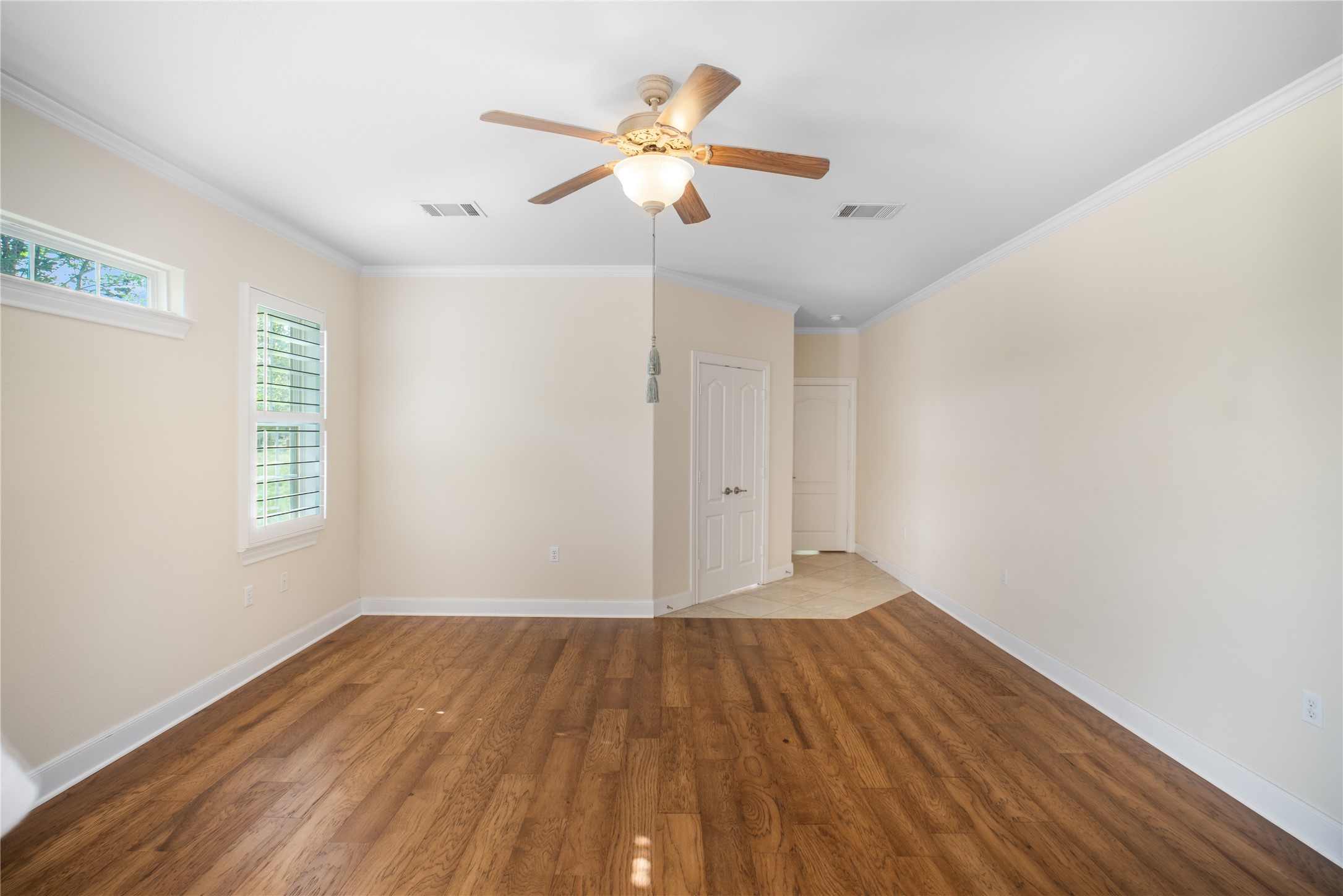 214 Summit Street Georgetown, TX 78633 - Photo 20 of 38 Living area featuring hardwood flooring, light colored walls, a ceiling fan with light fixture, and windows with blinds